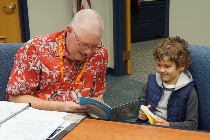 <p>H.C. Storm student showing off his excellent reading skills with Board Vice President Jon Gaspar. </p>
