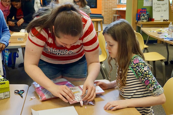 <p>NIU biomedical and electrical engineering student Amy Kofoed helping create the “who let the dog out” envelope.</p>
