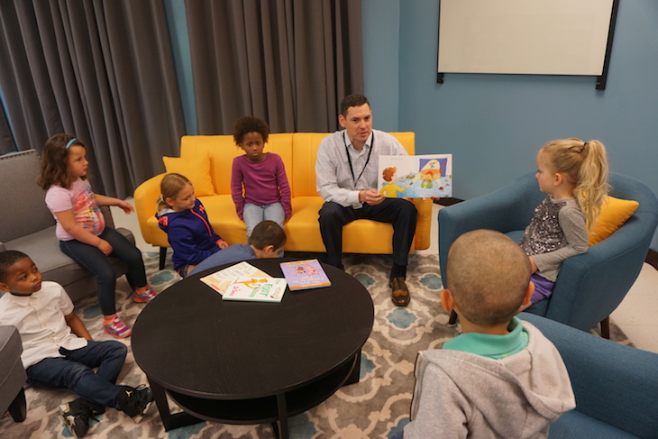 <p>BPS101 Chief Financial Officer reading on one of the new yellow sofas. The furnishings in the new space are so fun!</p>
