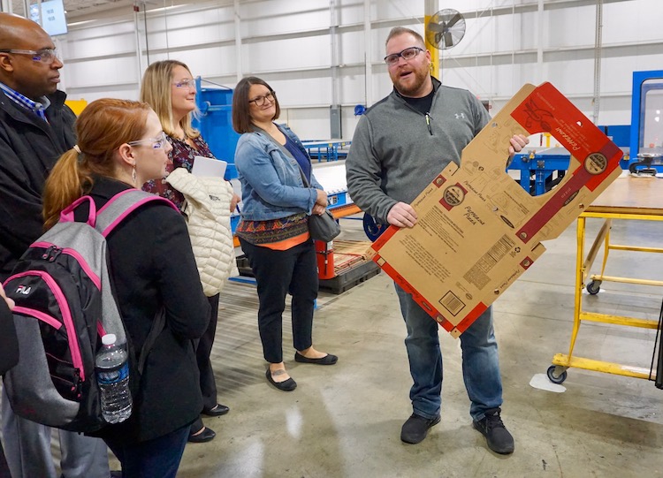 <p>During the tour of Batavia Container Inc., BCI Production Supervisor Andrew Hamilton (right) showed attendees the various type of corrugated packaging solutions that BCI produces … and how it’s done.</p>
