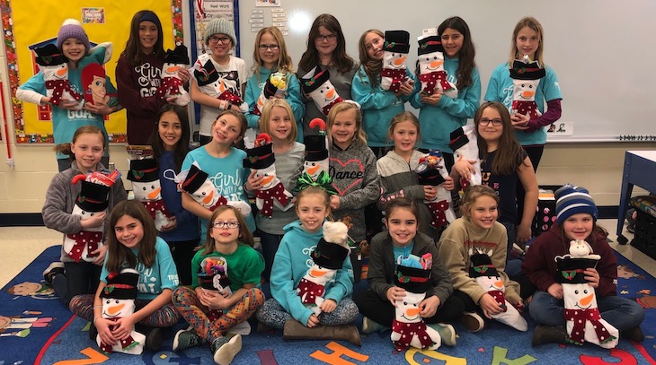 Several Scouts also stuffed stockings for Adopt-A-Family, including Grace McWayne Elementary School Girl Scout Troop #717.