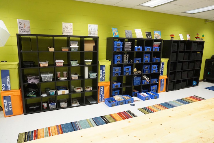 The wall of storage is used for reusable supplies and projects in progress.