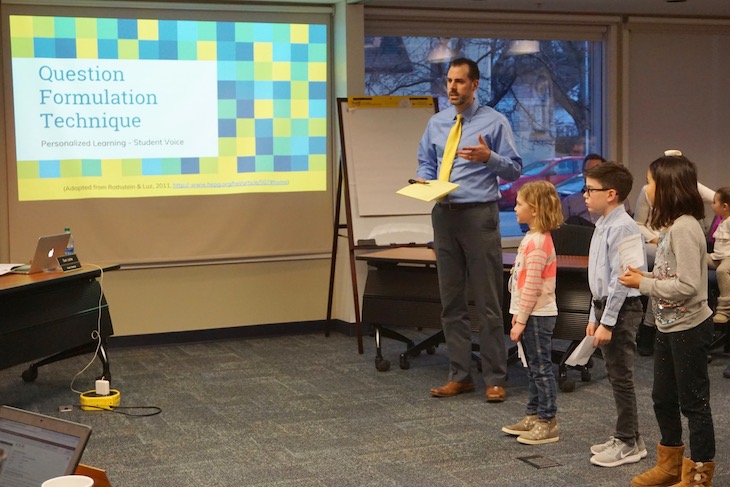 <p>Grace McWayne Principal Jeff Modaff and GMS second-graders explaining Question Formulation Technique (QFT) to Board Members.</p>
