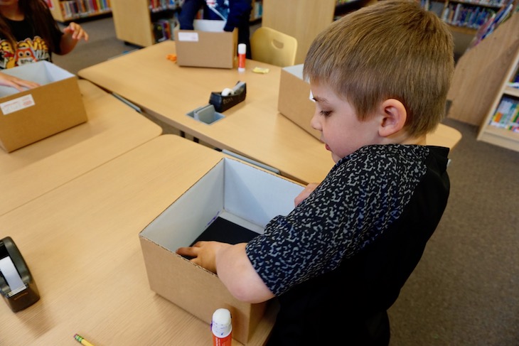 After the 2D/3D lesson, students got their "geoboxes" and applied a piece of black paper to the back.