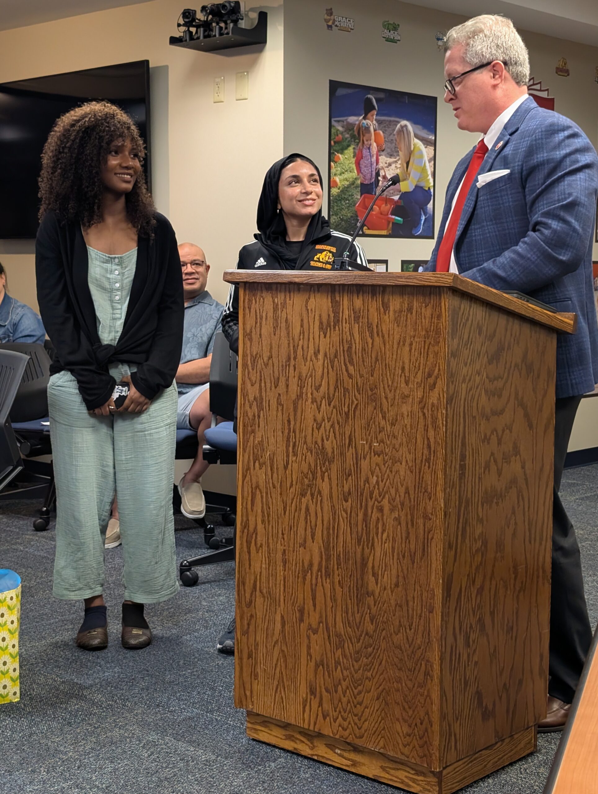 <p>Board Vice President Aaron Kilburg thanks student ambassadors Diorite Ilengero and Zahra Ahmad for serving the board for the past three years.</p>

