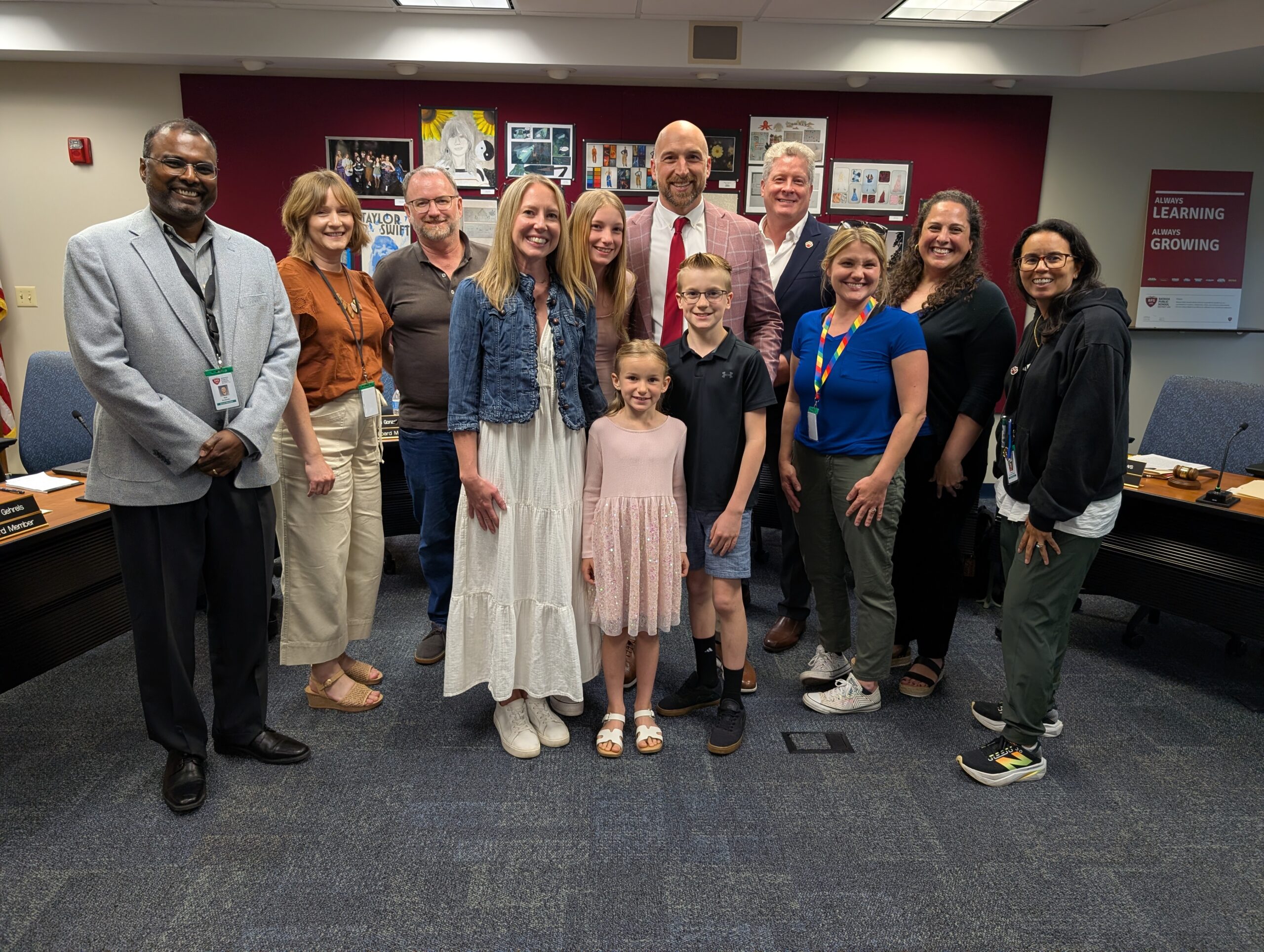 <p>Josh Louis and family with Board of Education</p>