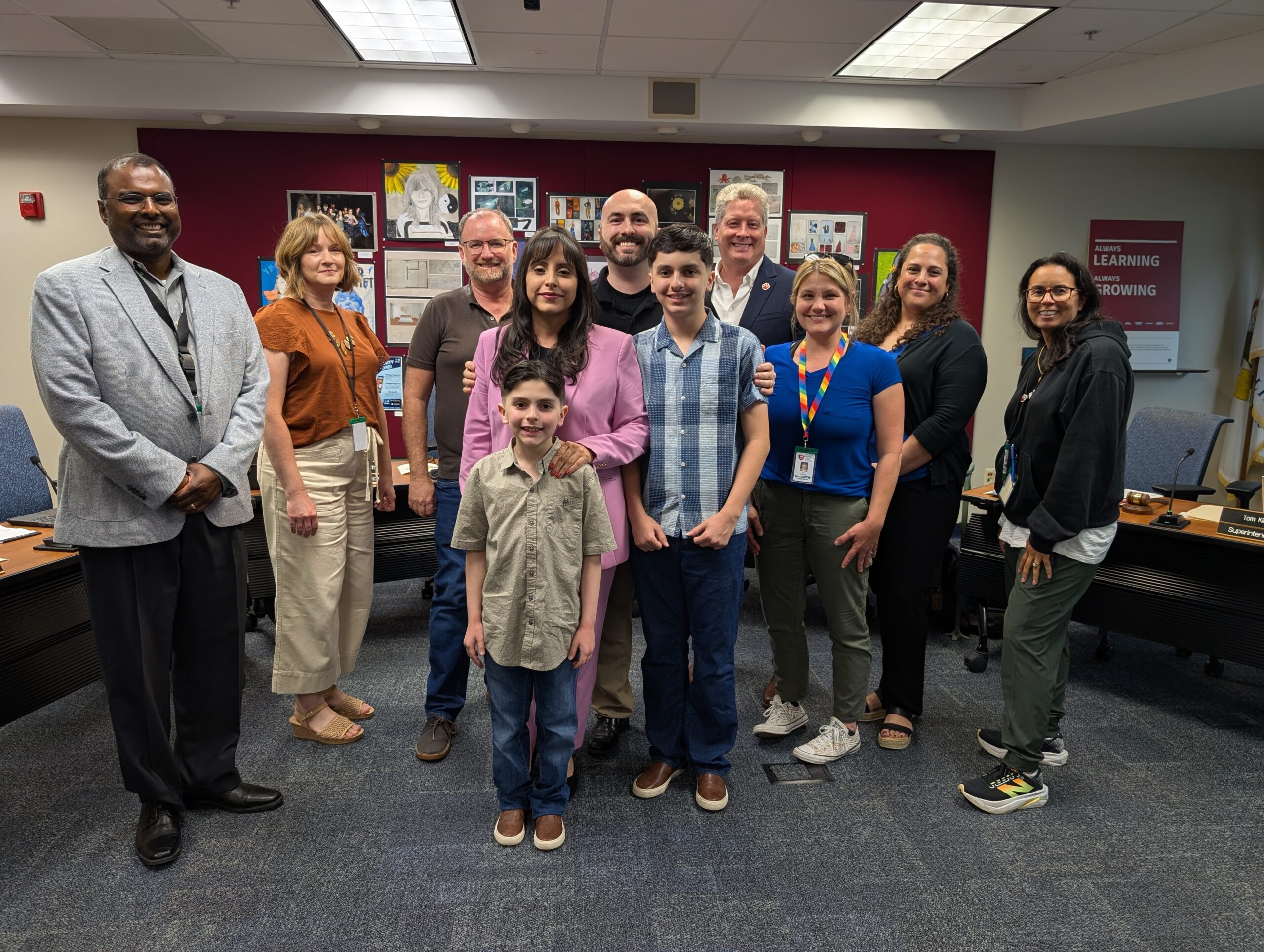 <p>Lissette Jacobson and family with Board of Education</p>