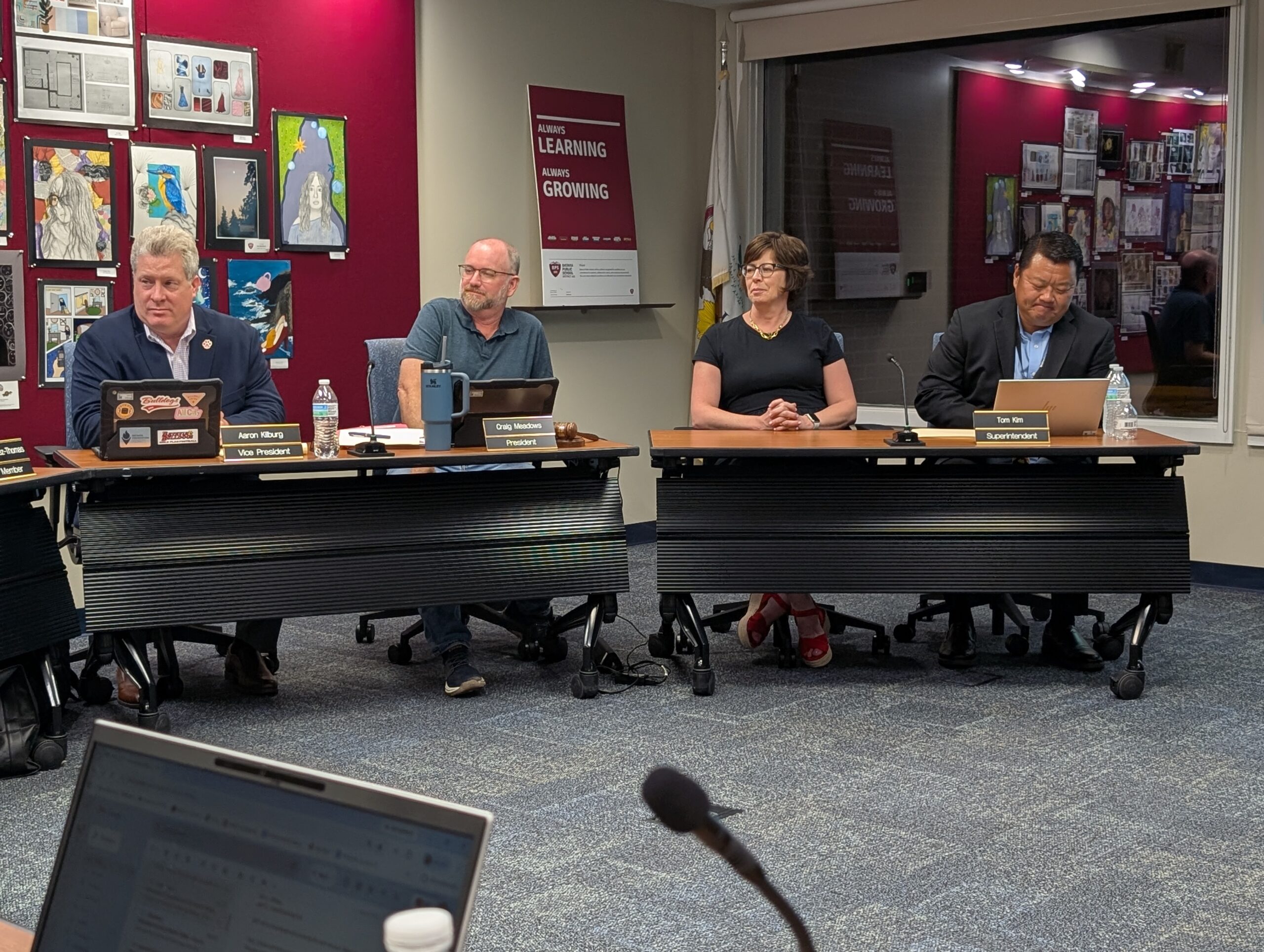 <p>Tara Gray sits at the Board table</p>