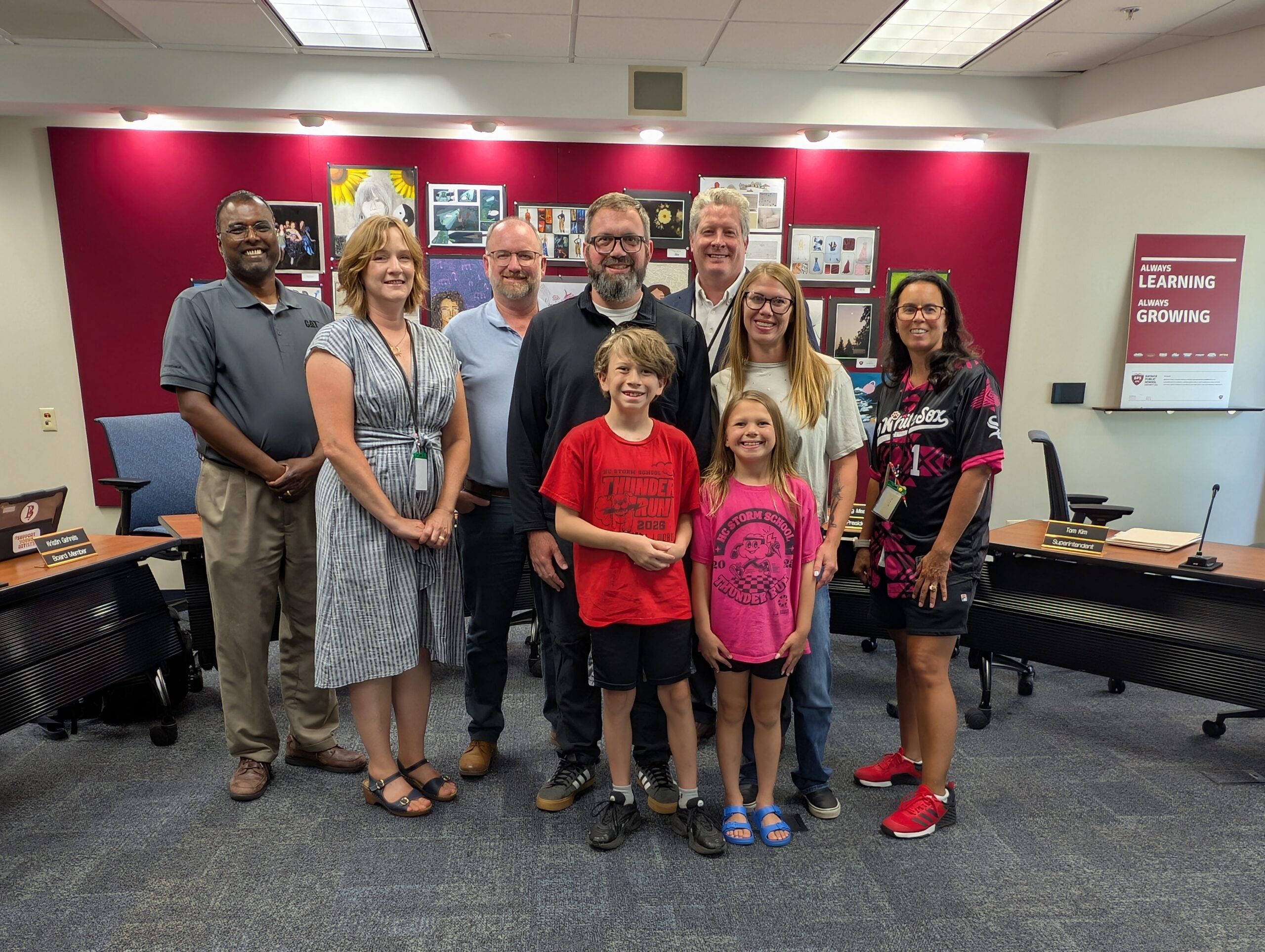 <p>Patrick Ryan and his family with the Board of Education</p>