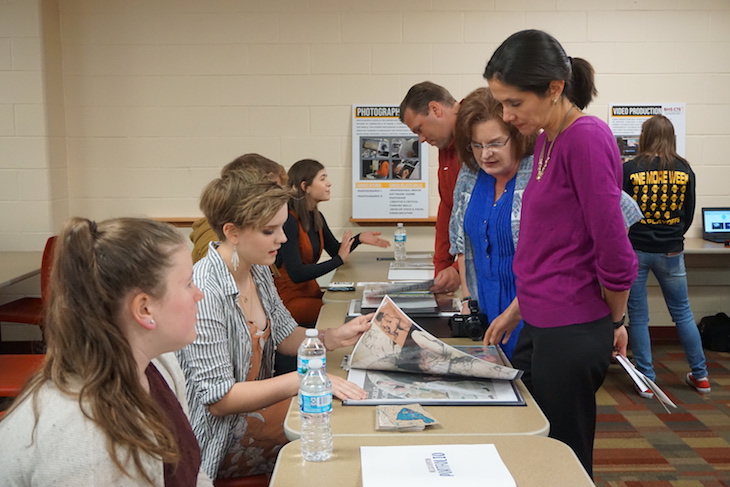 <p>BHS Graphic Arts students showing their portfolios.</p>
