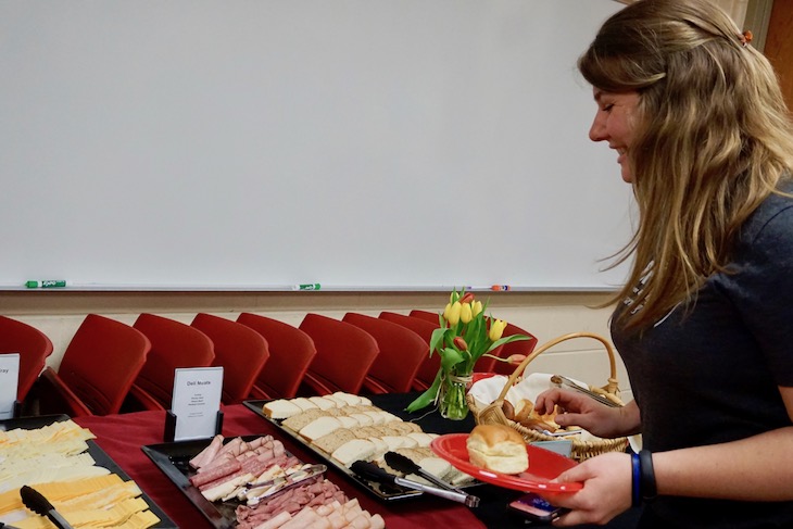 <p>BHS Culinary Arts Teacher Austun Savitski sampling the work of her students.</p>
